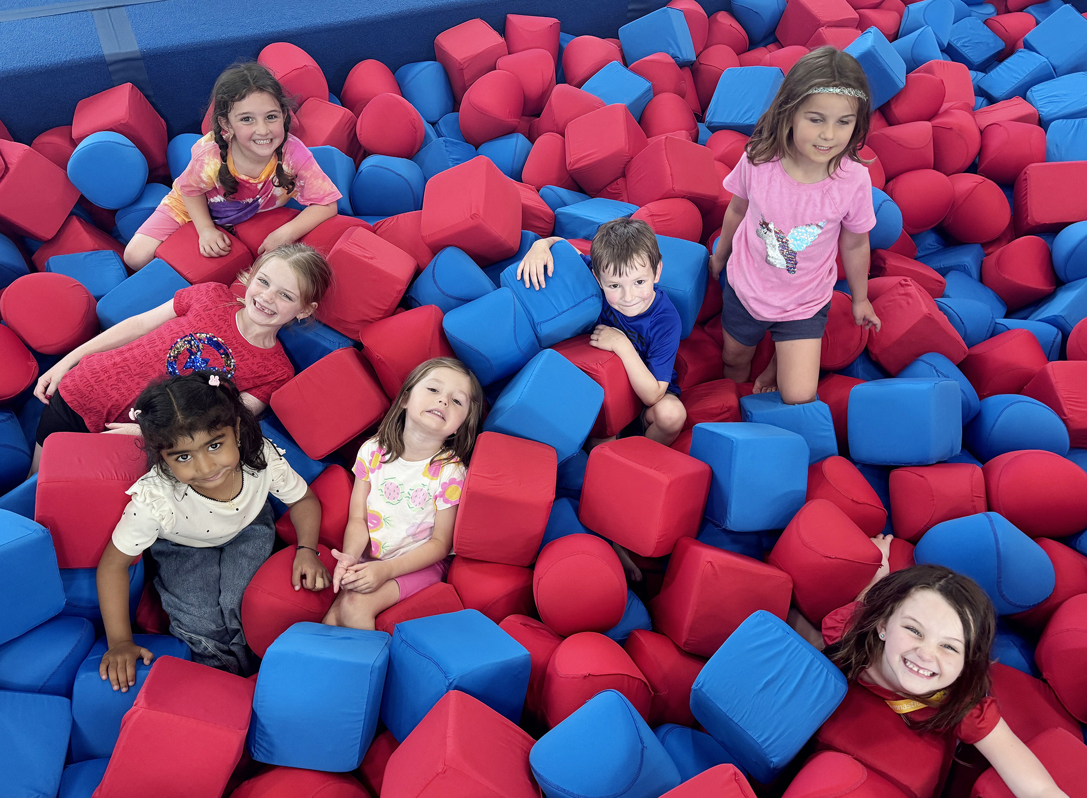 Children playing together in the foam pit at Metro Stars